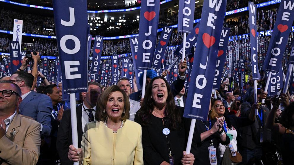 PHOTO: Former House Speaker Nancy Pelosi and her daughter Christine Pelosi hold "We Love Joe" signs as he speaks on the first day of the Democratic National Convention, in Chicago, Aug. 19, 2024.