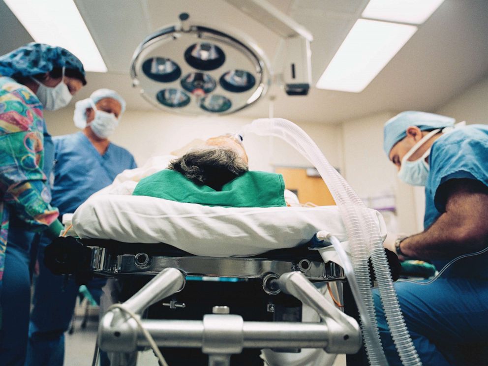PHOTO: An undated stock photo shows a doctor and nurses standing next to a patient.