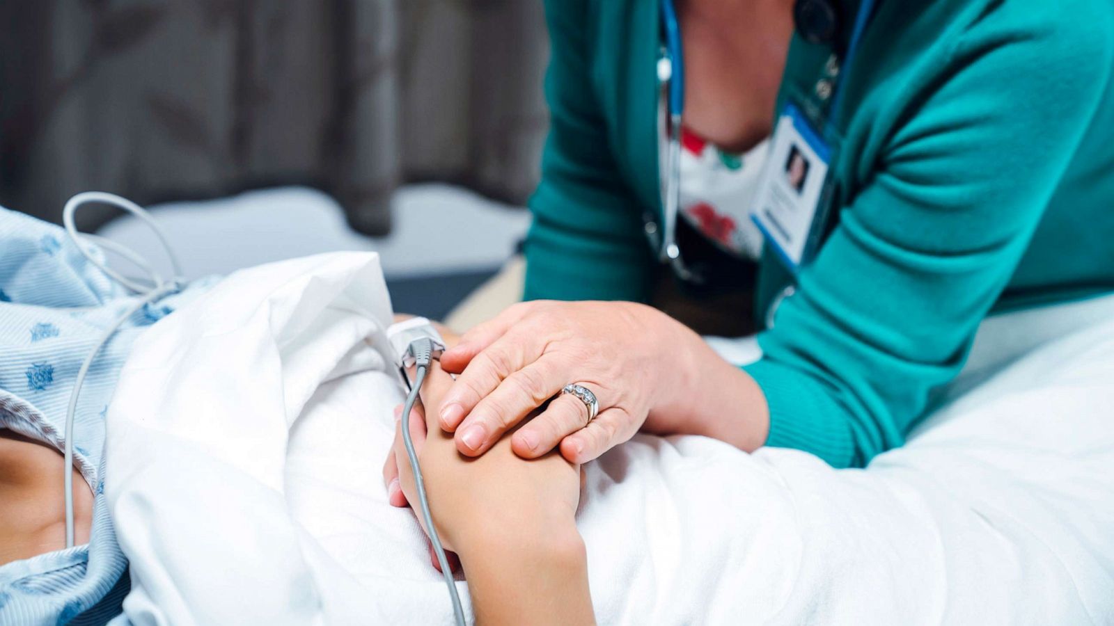 PHOTO: A doctor sits with a patient in hospital bed in this undated stock photo.