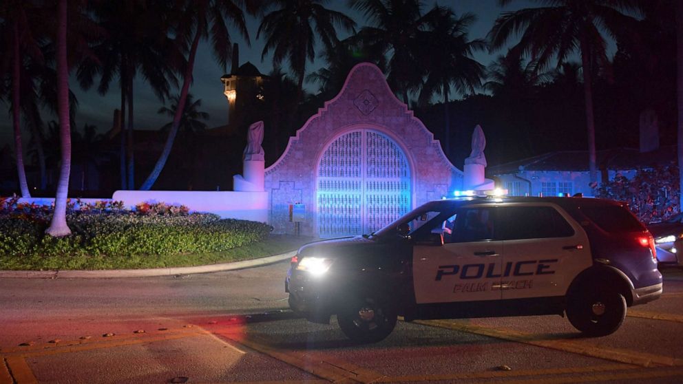 PHOTO: Authorities stand outside Mar-a-Lago, the residence of former president Donald Trump, amid reports of the FBI executing a search warrant as a part of a document investigation, in Palm Beach, Fla., Aug. 8, 2022.