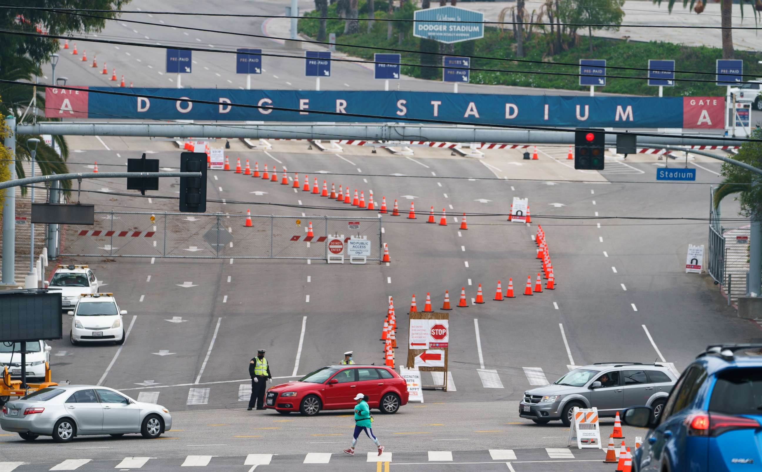 PHOTO: Motorists are redirected from the Dodger Stadium main gate to an alternate entrance as they line up to receive a COVID-19 vaccine at a Los Angeles County location at Dodger Stadium in Los Angeles Wednesday, Feb. 10, 2021. 