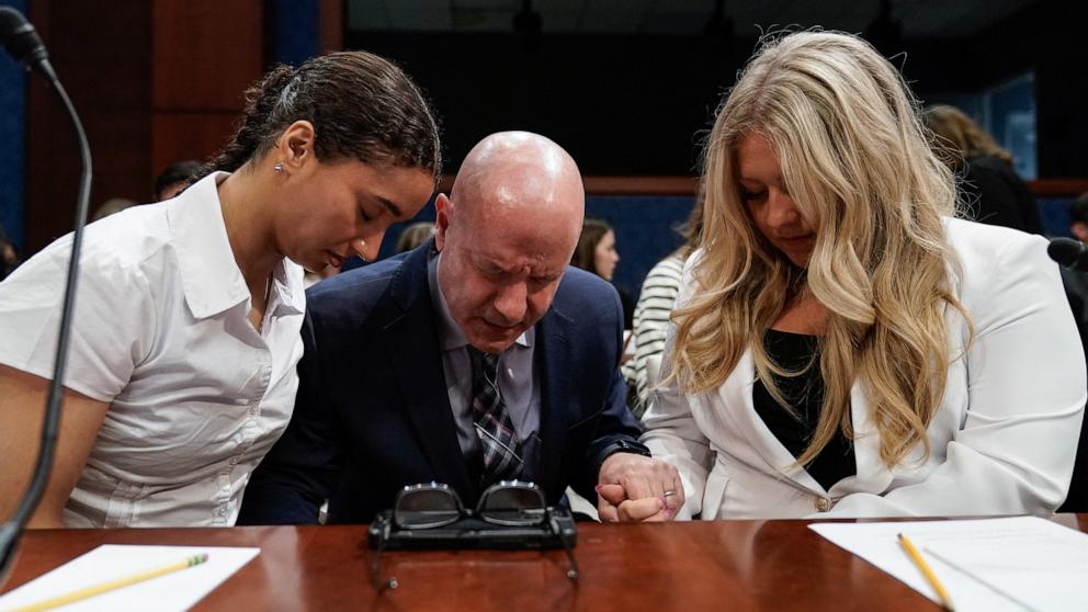 PHOTO: Stephanie Turner, a U.S. fencer who refused to compete against a transgender opponent, and former high school volleyball player Payton McNabb pray with a supporter before the start of a House Oversight DOGE Subcommittee in Washington, May 7, 2025. 