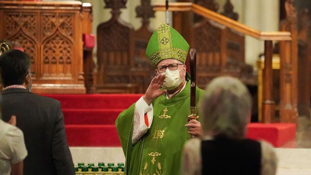 PHOTO: Archbishop of New York Timothy Dolan speaks to people at the end of the service inside St. Patrick's Cathedral, June 28, 2020 in New York.