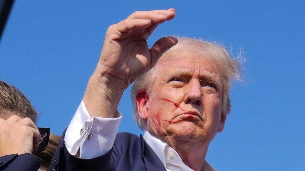 PHOTO: Republican presidential candidate former President Donald Trump waves from the stage as he is surrounded by U.S. Secret Service agents at a campaign rally, July 13, 2024, in Butler, Pa.
