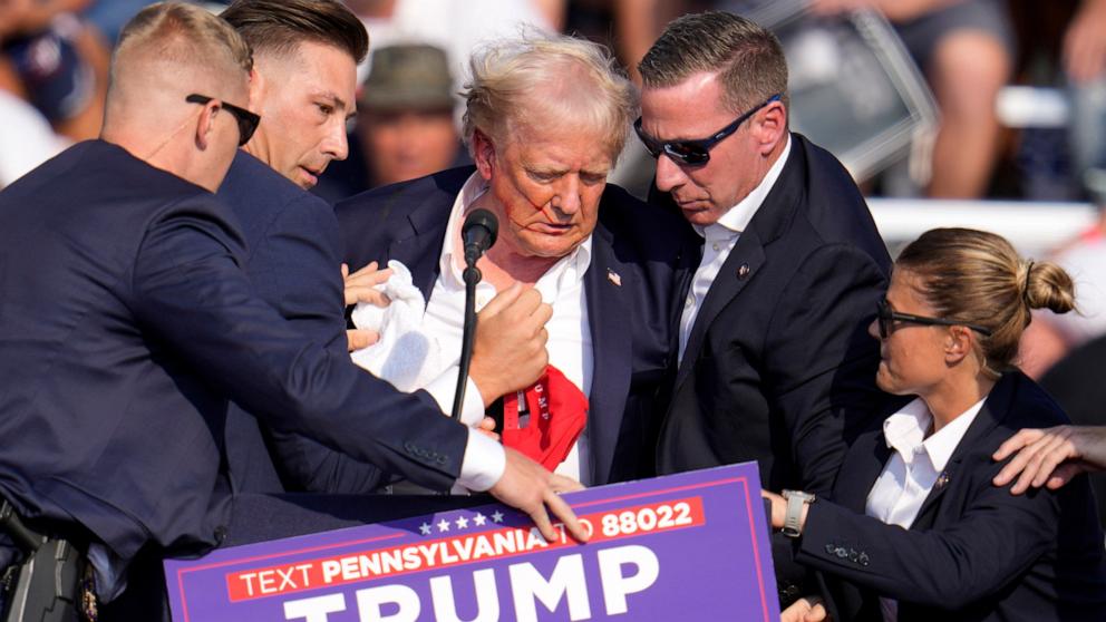 PHOTO: Republican presidential candidate former President Donald Trump is helped off the stage at a campaign event in Butler, Pa., July 13, 2024.