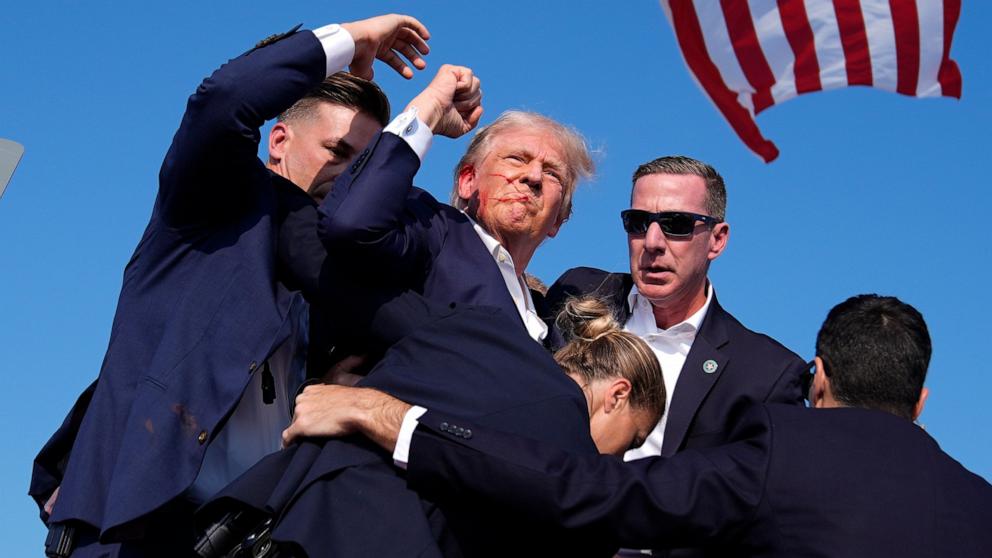 PHOTO: Republican presidential candidate former President Donald Trump is surround by U.S. Secret Service agents at a campaign rally, July 13, 2024, in Butler, Pa.