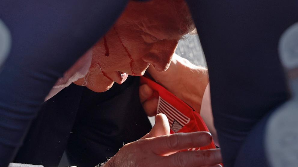 PHOTO: Secret Service tend to republican presidential candidate former President Donald Trump onstage at a rally, July 13, 2024, in Butler, Pennsylvania. 