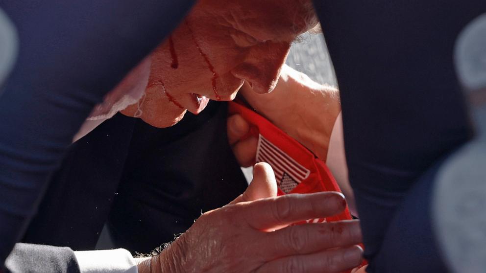 PHOTO: Secret Service tend to republican presidential candidate former President Donald Trump onstage at a rally, July 13, 2024, in Butler, Pennsylvania.