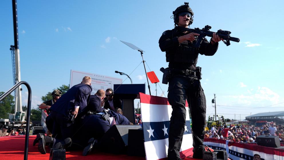 PHOTO: Republican presidential candidate former President Donald Trump is covered by U.S. Secret Service agents at a campaign rally, July 13, 2024, in Butler, Pa. 