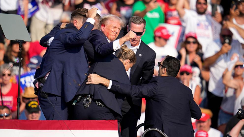 PHOTO: Republican presidential candidate former President Donald Trump is helped off the stage at a campaign event in Butler, Pa., July 13, 2024.
