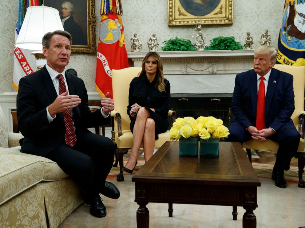 PHOTO: President Donald Trump and first lady Melania Trump listen as acting FDA Commissioner Ned Sharpless talks about a plan to ban most flavored e-cigarettes, in the Oval Office of the White House, Sept. 11, 2019, in Washington.