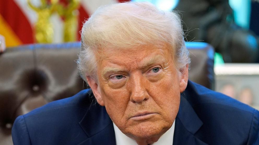 PHOTO: President Donald Trump listens to a question from a reporter as he signs executive orders in the Oval Office of the White House, April 17, 2025, in Washington.