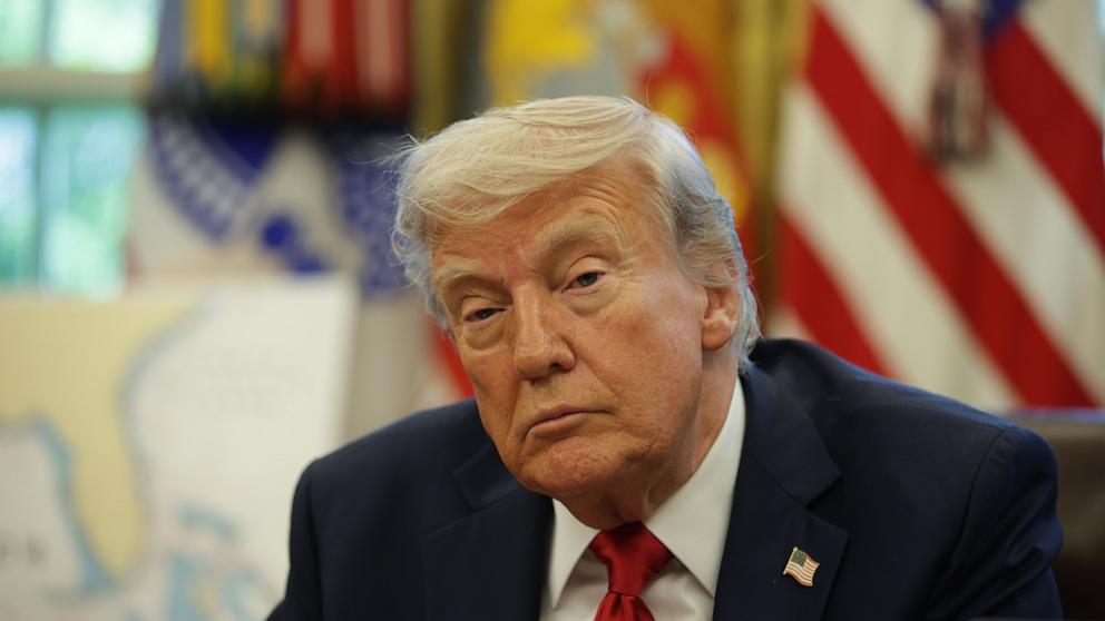 PHOTO: President Donald Trump speaks with reporters after signing executive orders in the Oval Office of the White House, April 23, 2025, in Washington.