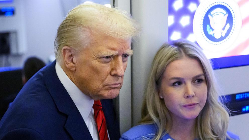 PHOTO: President Donald Trump, next to White House Press Secretary Karoline Leavitt, speaks to reporters while in flight on Air Force One en route Joint Base Andrews, Jan. 27, 2025.