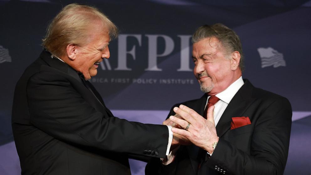 PHOTO: President-elect Donald Trump greets actor Sylvester Stallone onstage at the America First Policy Institute Gala held at Mar-a-Lago on Nov. 14, 2024, in Palm Beach, Florida.