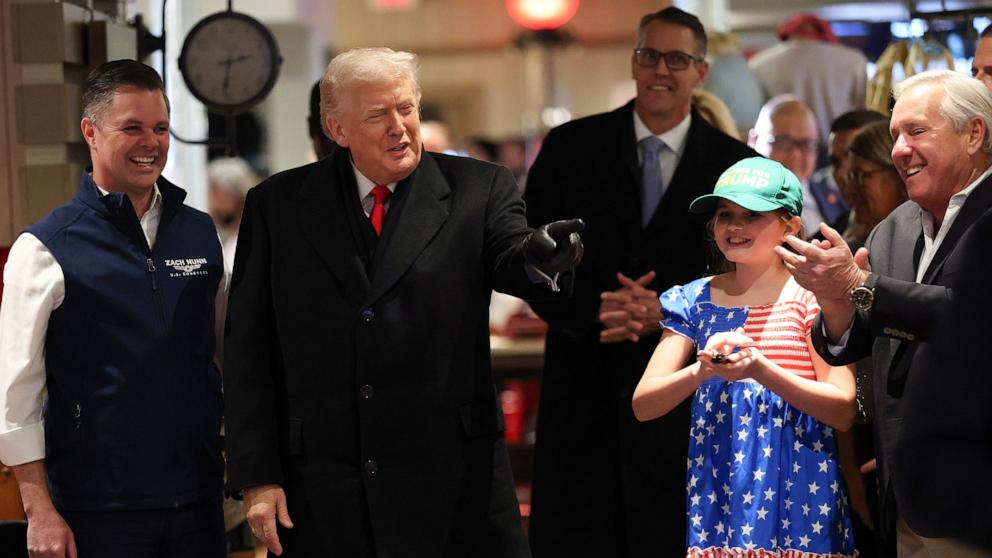 PHOTO: President Donald Trump greets patrons as he visits the Machine Shed restaurant, January 27, 2026 in Urbandale, Iowa.