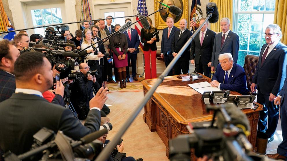 PHOTO: President Donald Trump speaks to reporters as he signs an executive order, in the Oval Office, at the White House in Washington, Feb. 14, 2025.