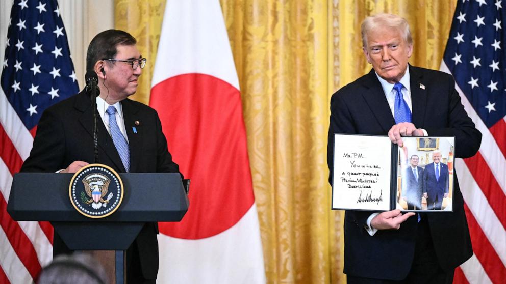 PHOTO: President Donald Trump holds up a photograph of their earlier Oval Office meeting during a joint news conference with Japanese Prime Minister Shigeru Ishiba in the East Room of the White House in Washington, Feb. 7, 2025.