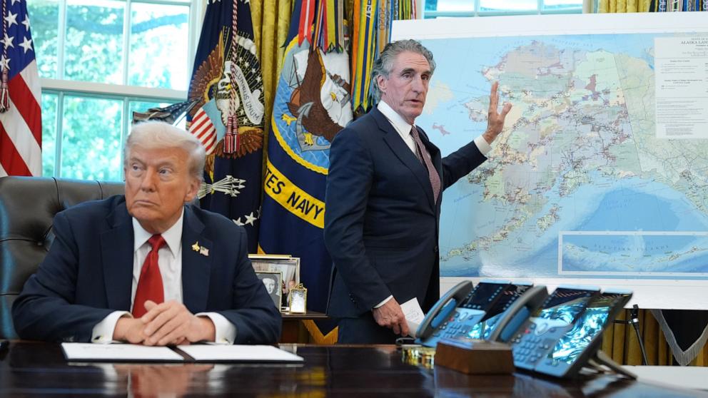 PHOTO: President Donald Trump listens as Interior Secretary Doug Burgum speaks to reporters in the Oval Office at the White House, Oct. 6, 2025, in Washington.