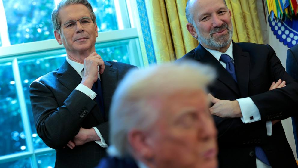 PHOTO: Treasury Secretary Scott Bessent and Secretary of Commerce Howard Lutnick watch as President Donald Trump signs an executive order in the Oval Office of the Whit