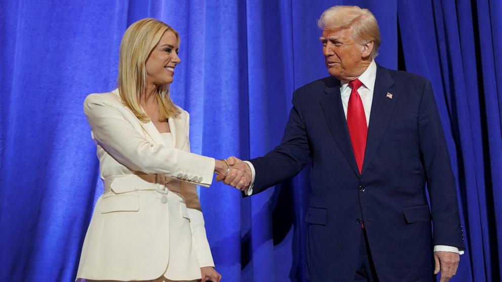 PHOTO: President Donald Trump and Attorney General Pam Bondi shake hands during his visit to the Department of Justice to address its workers, in Washington, Mar. 14, 2025.