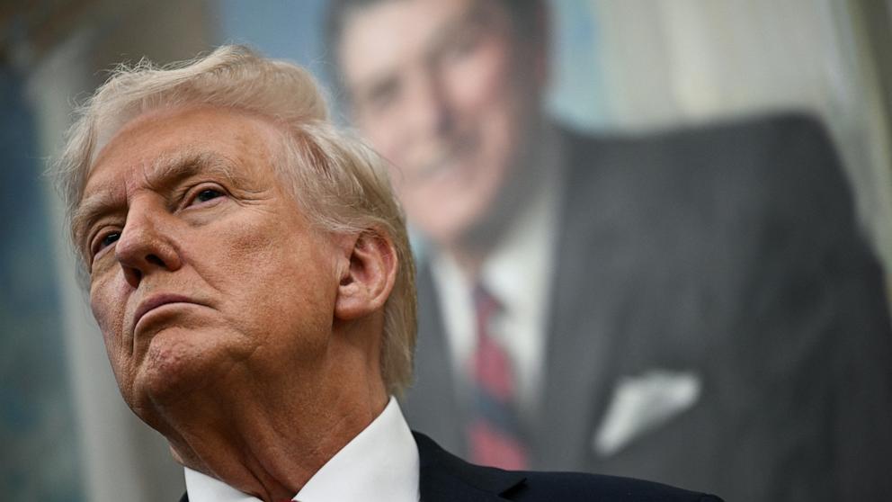 PHOTO: A portrait of former US President Ronald Reagan hangs behind President Donald Trump as Trump makes an announcement on prescription drugs in the Oval Office of the White House in Washington, September 30, 2025