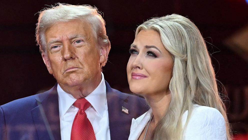 PHOTO: President Donald Trump greets Erika Kirk, Charlie Kirk's widow during the public memorial service for right-wing activist Charlie Kirk at State Farm Stadium in Glendale, Arizona, September 21, 2025. 