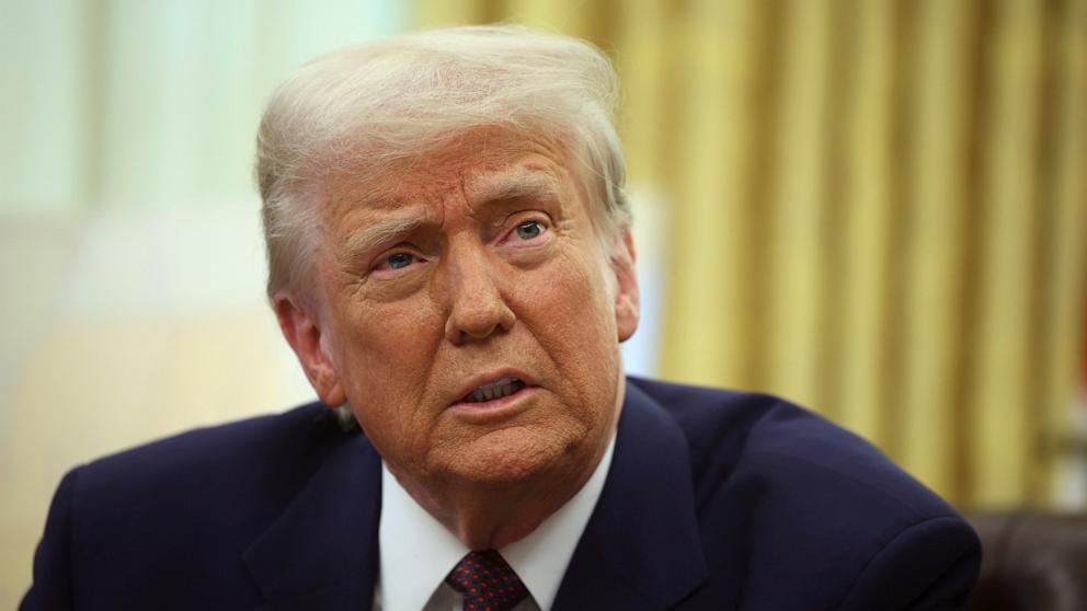 PHOTO: President Donald Trump speaks with reporters as he signs executive orders in the Oval Office at the White House in Washington, Feb. 13, 2025.