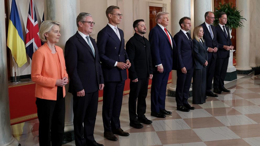 PHOTO: Ukrainian President Volodymyr Zelensky and President Donald Trump pose for a family photo with European leaders in the Cross Hall of the White House in Washington, August 18, 2025.