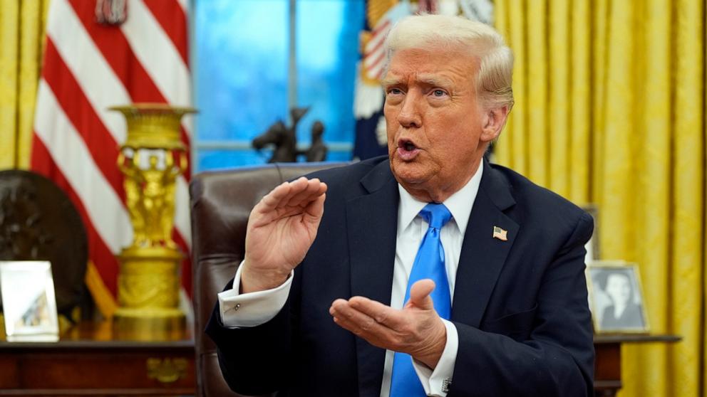 PHOTO: President Donald Trump speaks with reporters as he signs an executive order in the Oval Office at the White House, Feb. 11, 2025, in Washington.