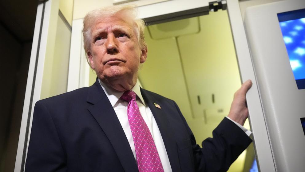 PHOTO: President Donald Trump talks to members of the media aboard Air Force One en route to Joint Base Andrews, Maryland, March 29, 2026.