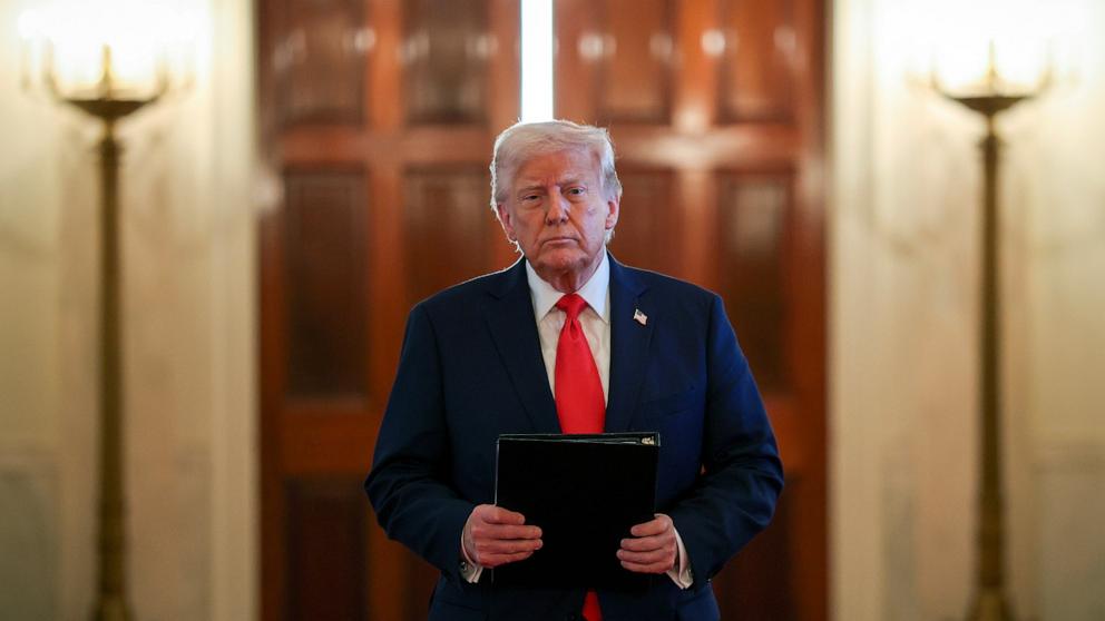 PHOTO: President Donald Trump arrives at a ceremony to present the Commander-in-Chief's Trophy to the US Naval Academy football team, the Navy Midshipmen, in the East Room of the White House, April 15, 2025 in Washington.