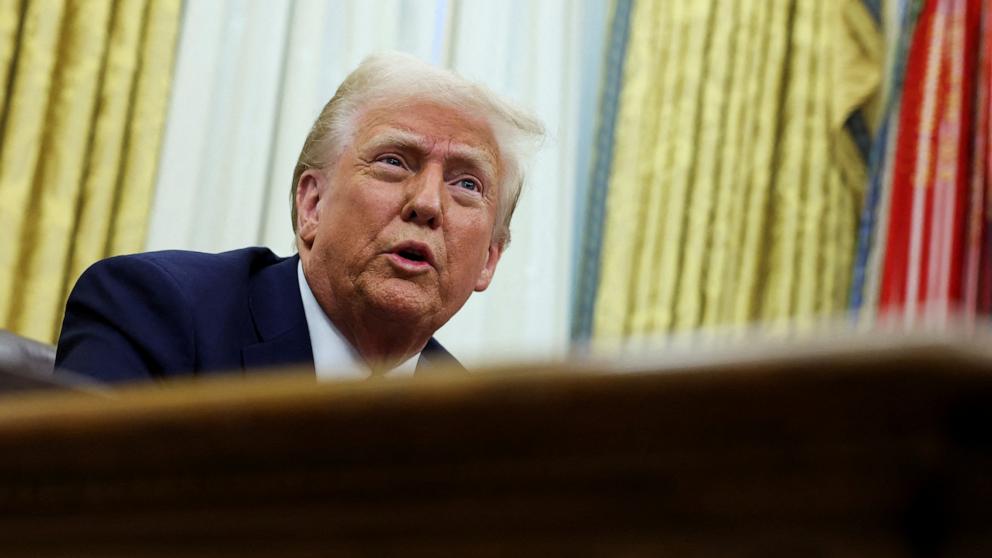 PHOTO: President Donald Trump sits in the Oval Office of the White House, as he signs executive orders, in Washington, Jan. 23, 2025.