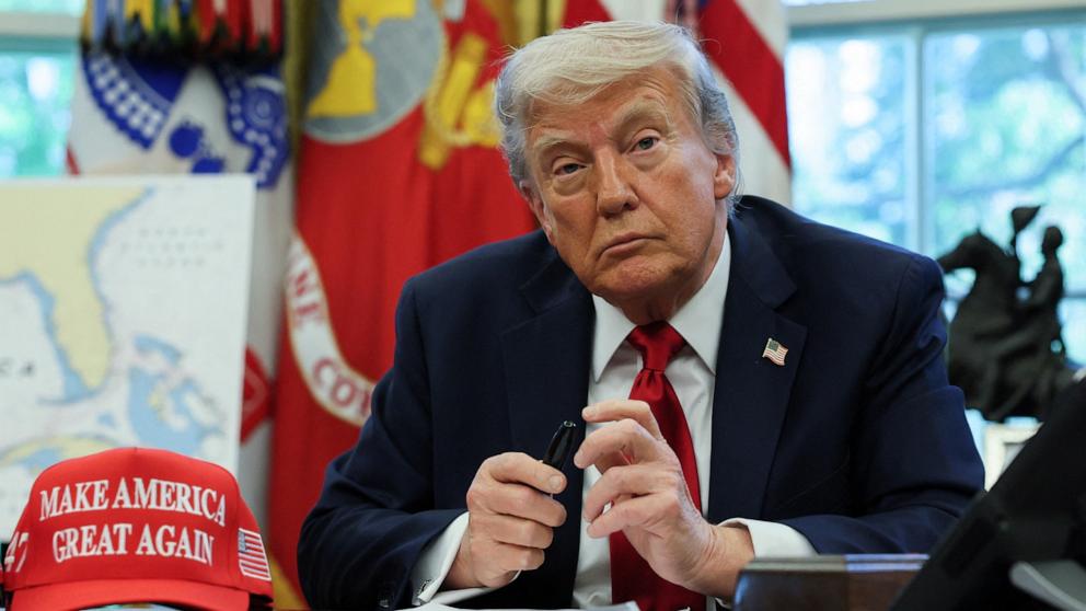 PHOTO: President Donald Trump speaks with reporters after signing executive orders in the Oval Office of the White House, April 23, 2025, in Washington.