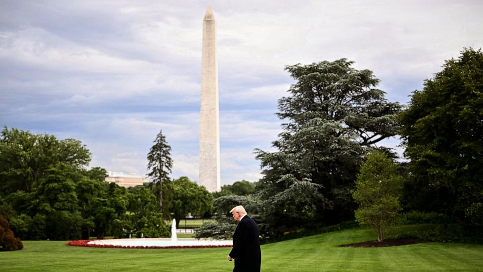 PHOTO: The Washington Monument is seen in the distance as US President Donald Trump walks to board Marine One before departing from the South Lawn of the White House in Washington, May 22, 2025.