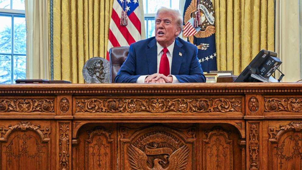 PHOTO: President Donald Trump talks to reporters from the Resolute Desk after signing an executive order to appoint the deputy administrator of the Federal Aviation Administration in the Oval Office at the White House on January 30, 2025 in Washington.