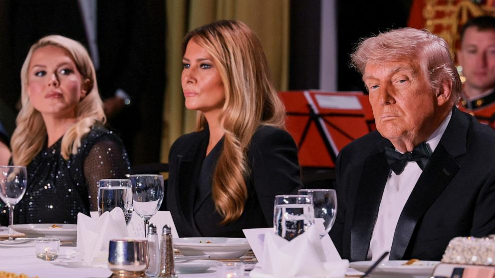 PHOTO: President Donald Trump and first lady Melania Trump, next to White House Press Secretary Karoline Leavitt, attend the annual White House Correspondents' Association dinner in Washington, April 25, 2026. 
