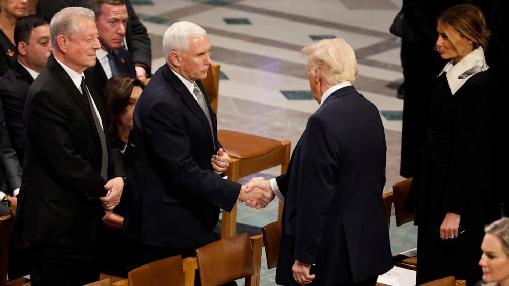 PHOTO: President-elect Donald Trump greets former Vice President Mike Pence as he arrives with Melania Trump during the state funeral for former U.S. President Jimmy Carter at Washington National Cathedral, Jan. 9, 2025, in Washington.