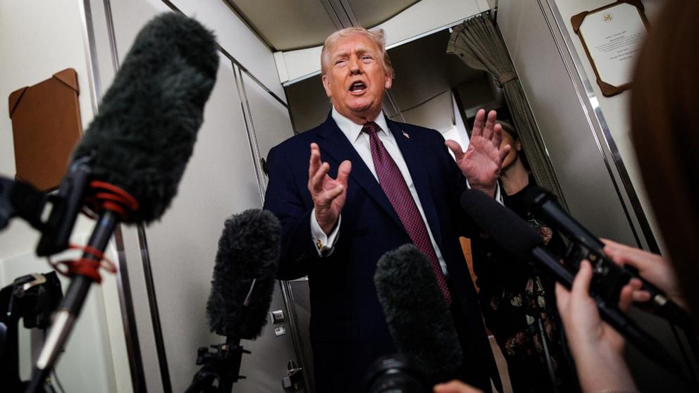 PHOTO: President Donald Trump takes questions from the members of the press aboard Air Force One en route back to the White House, January 11, 2026 in Palm Beach, Fla.