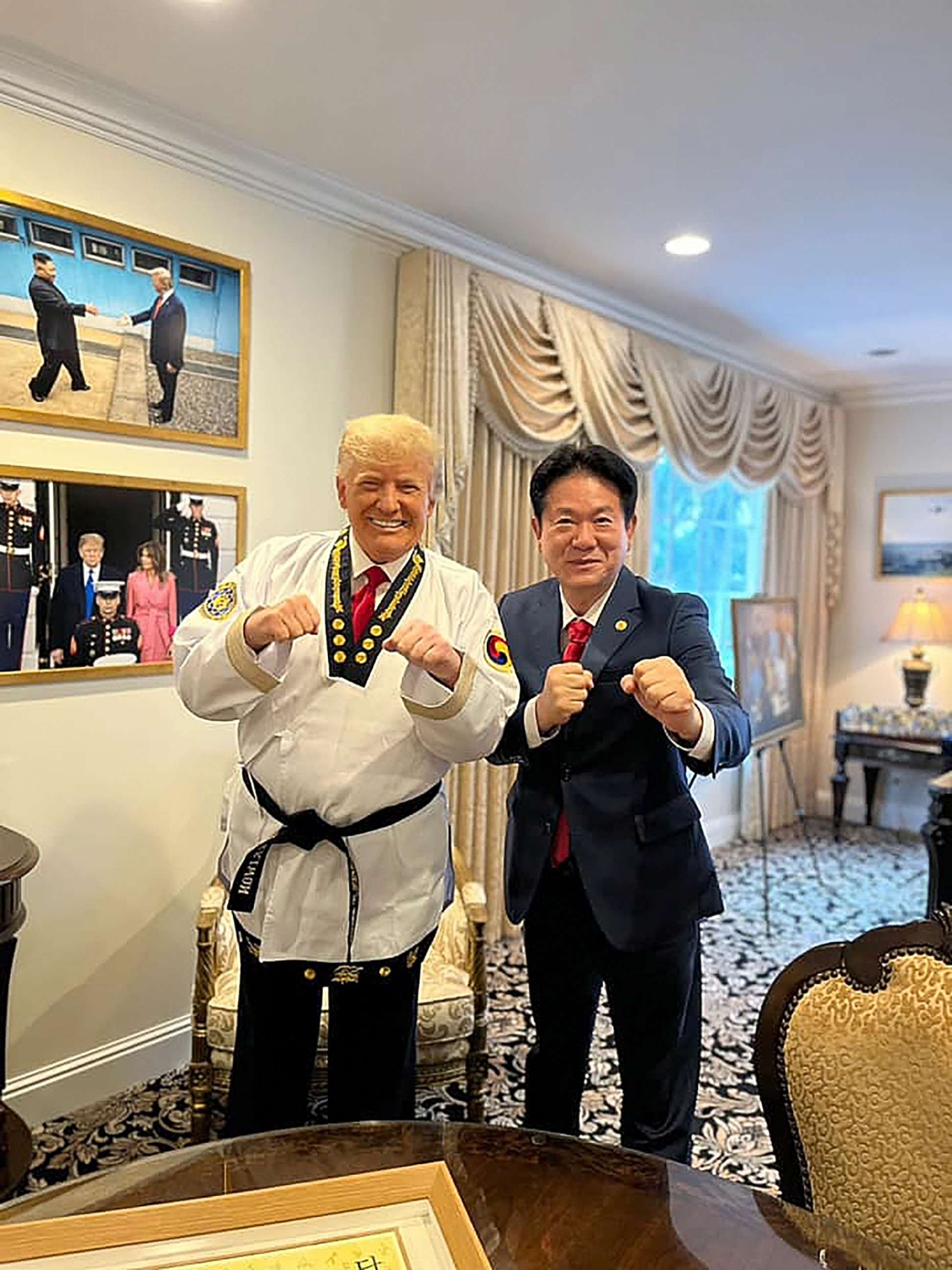 PHOTO: Kukkiwon World Taekwondo Headquarters president Lee Dong-sup with former president Donald Trump in Trump's Mar-a-Lago office, in a photo posted to the organizations Facebook page, Nov. 19, 2021.