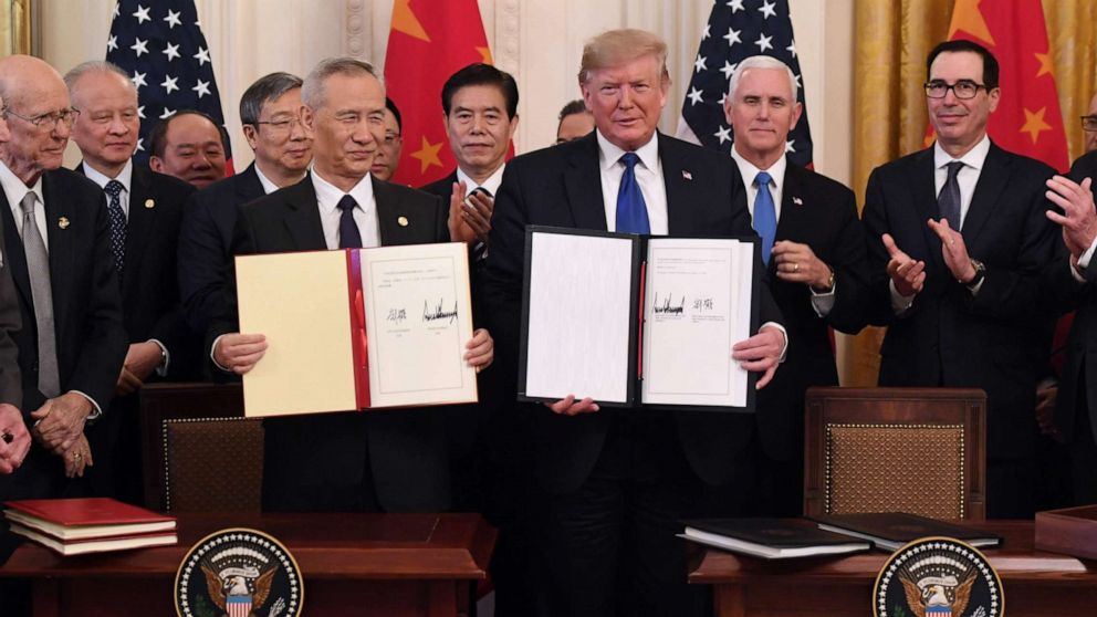 PHOTO: President Donald Trump and Chinese Vice Premier Liu He, hold a trade agreement between the U.S. and China during a ceremony in the East Room of the White House in Washington, Jan. 15, 2020.