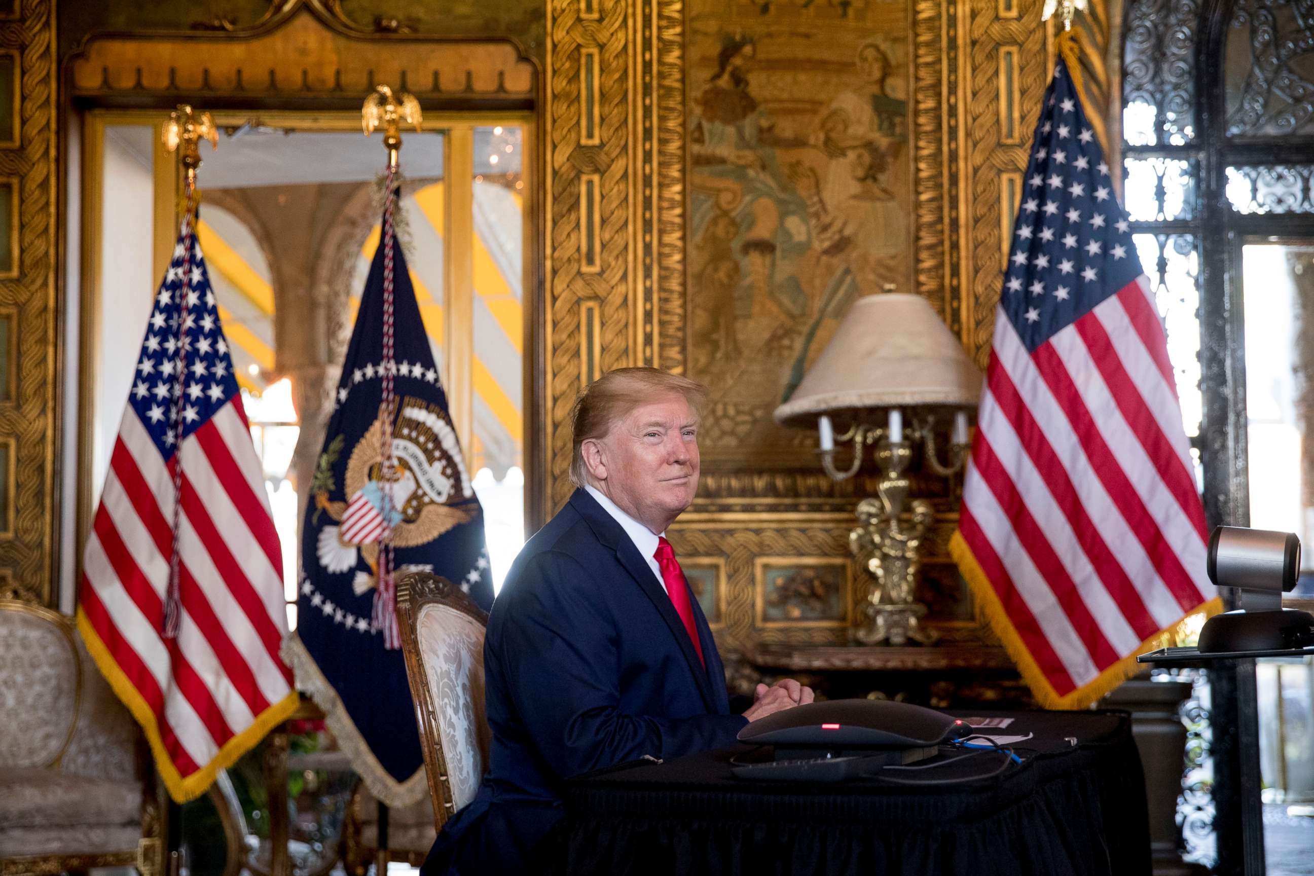 PHOTO: President Donald Trump looks towards members of the media as he speaks during a Christmas Eve video teleconference with members of the military at his Mar-a-Lago estate in Palm Beach, Fla., Dec. 24, 2019.