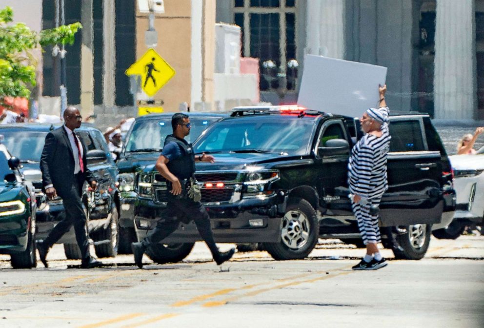 PHOTO: A man gestures as the motorcade of former President Donald Trump arrives at the Wilkie D. Ferguson Jr. United States Courthouse, for Trump to appear at his arraignment on classified document charges, in Miami, June 13, 2023.