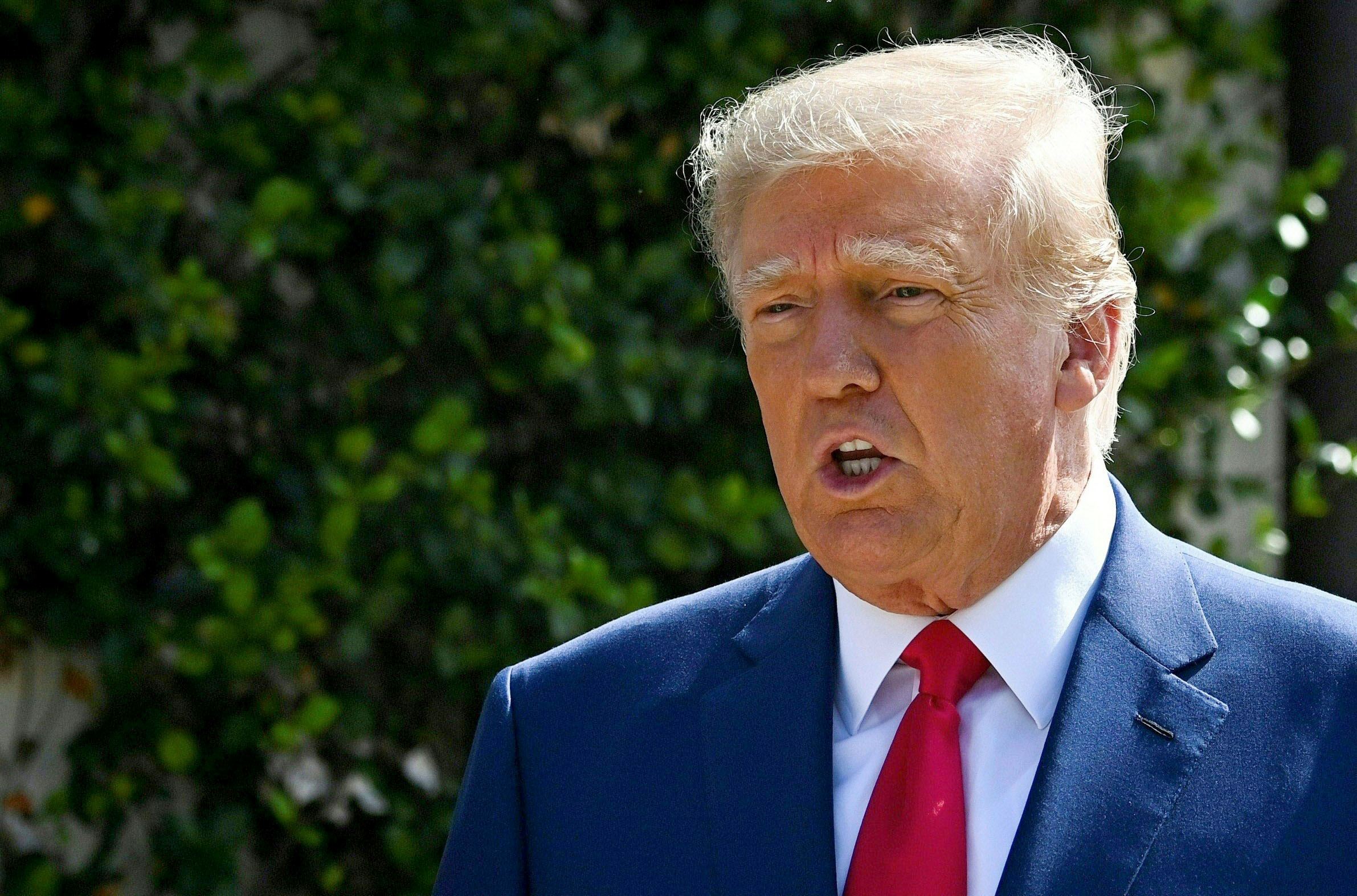 PHOTO: Donald Trump speaks to the media while departing a polling station after voting in the US midterm elections at Morton and Barbara Mandel in Palm Beach, Florida.