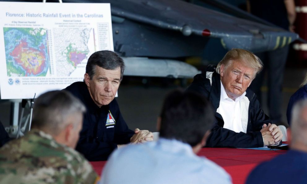 PHOTO: President Donald Trump and North Carolina Gov. Roy Cooper listen while attending a briefing, after Trump arrived at Marine Corps Air Station Cherry Point to visit areas impacted by Hurricane Florence, Sept. 19, 2018, in Havelock, N.C.