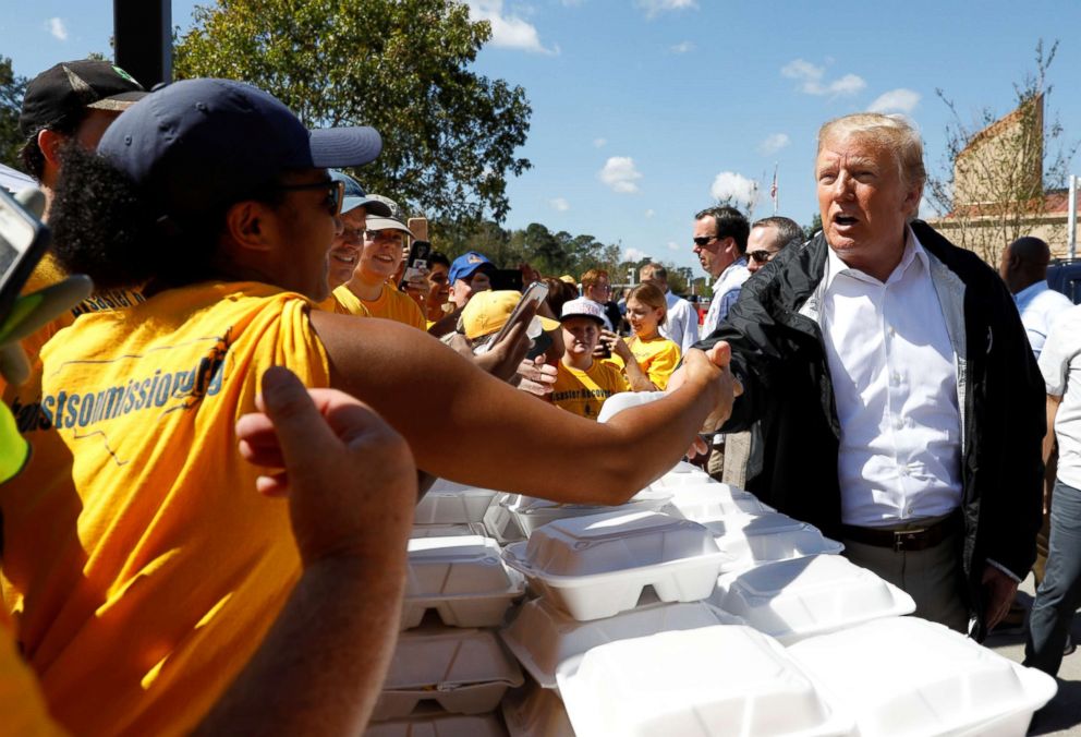 PHOTO: President Donald Trump greets people while distributing food after Hurricane Florence in New Bern, N.C., Sept. 19, 2018.