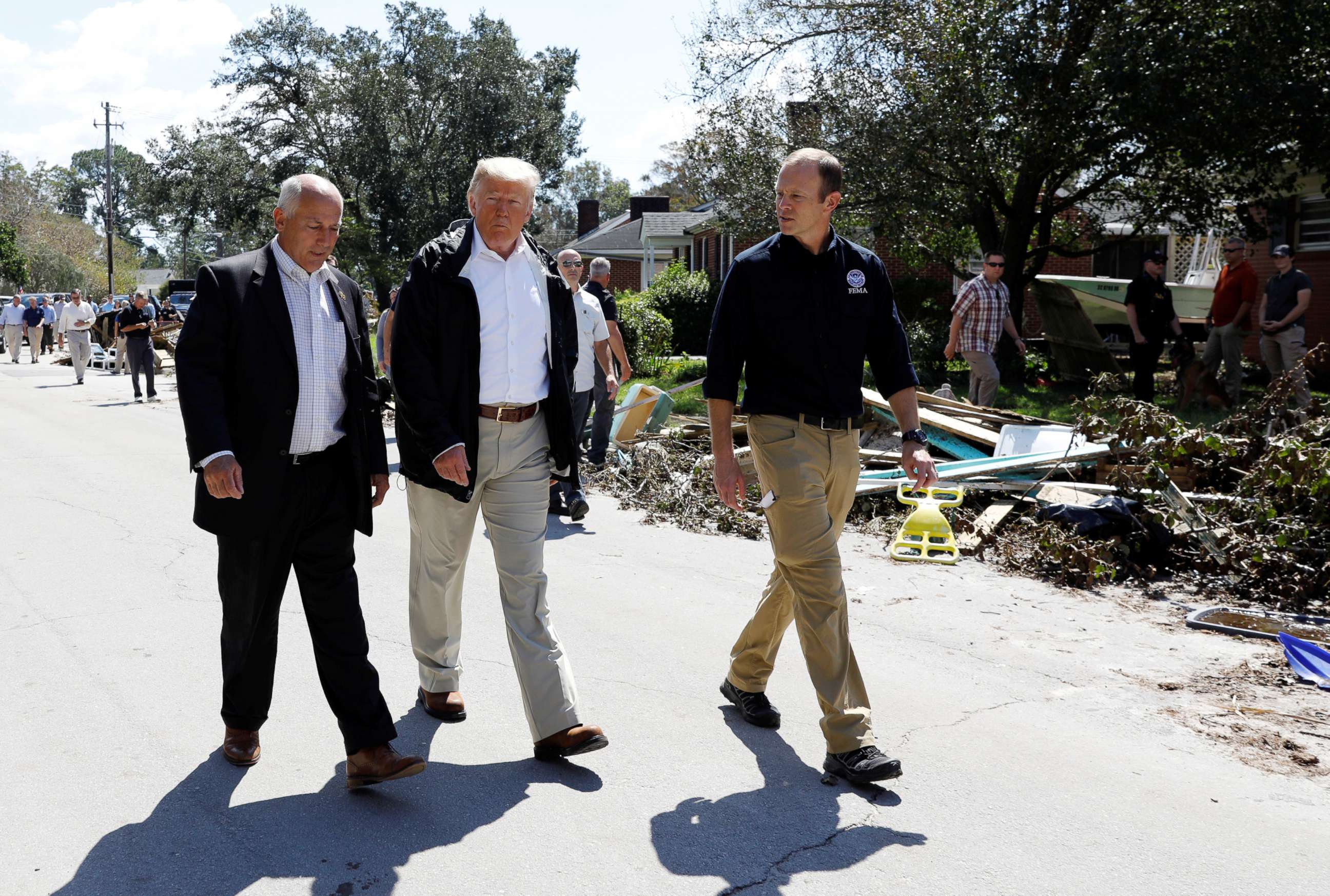 PHOTO: President Donald Trump walks down a street while on a tour of Hurricane Florence recovery efforts in New Bern, N.C., Sept. 19, 2018.