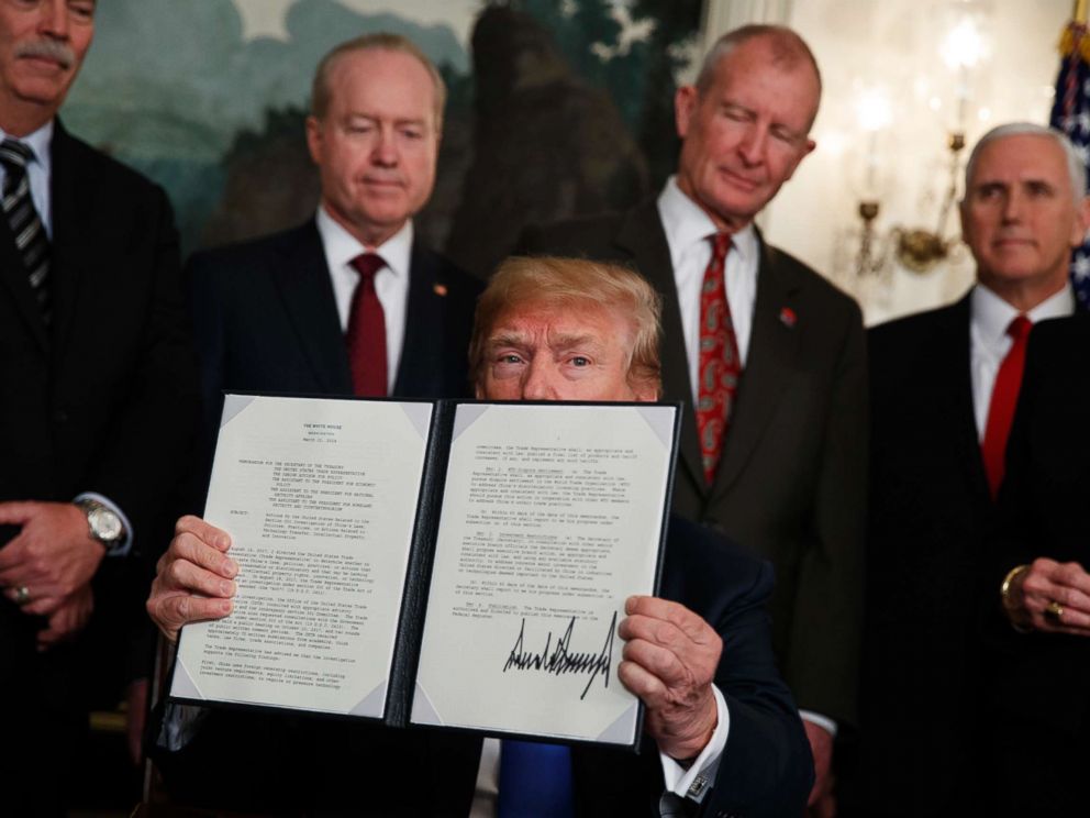PHOTO: President Donald Trump displays signs a presidential memorandum imposing tariffs and investment restrictions on China in the Diplomatic Reception Room of the White House, March 22, 2018, in Washington.