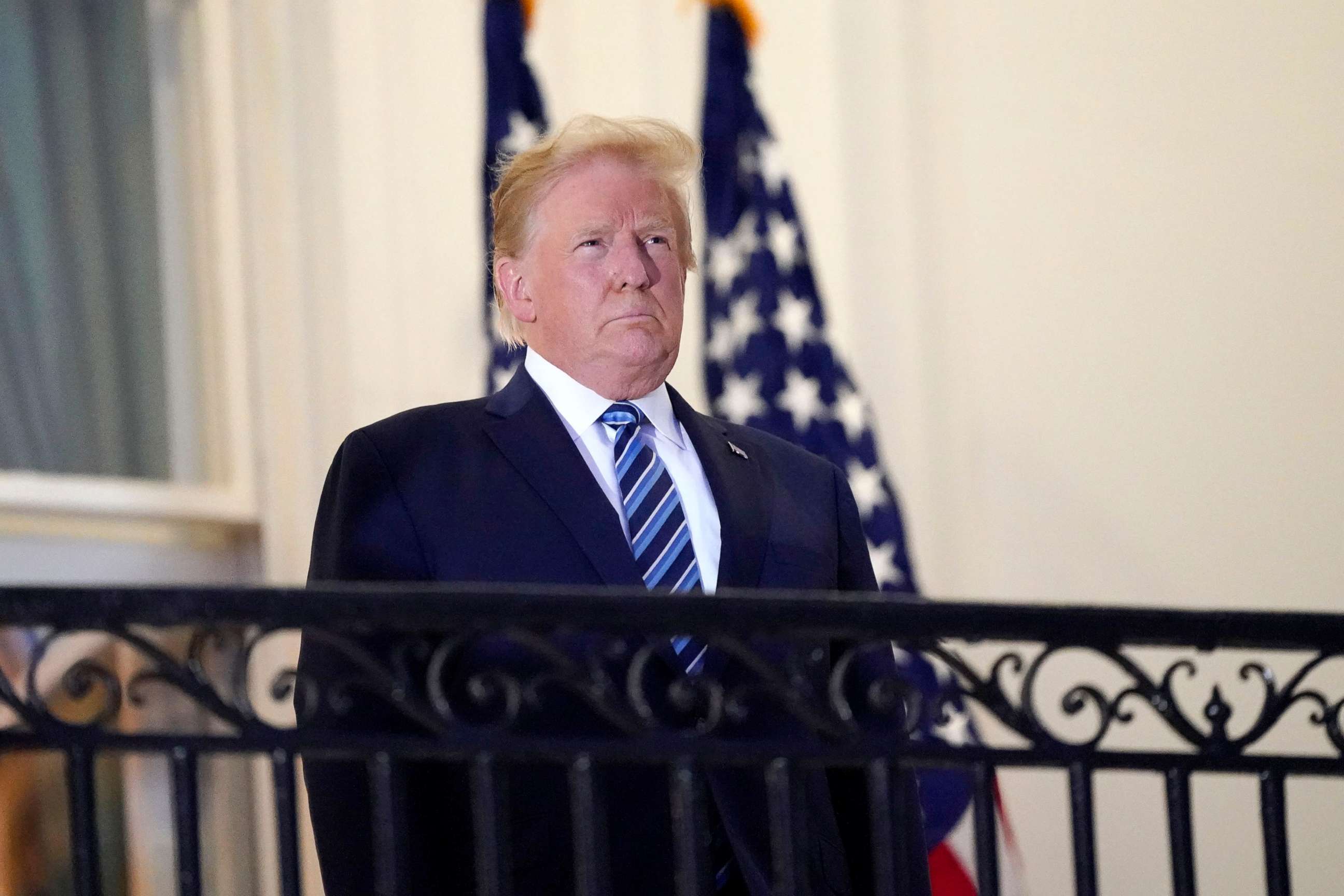PHOTO: President Donald Trump stands on the balcony outside of the Blue Room as returns to the White House Monday, Oct. 5, 2020.