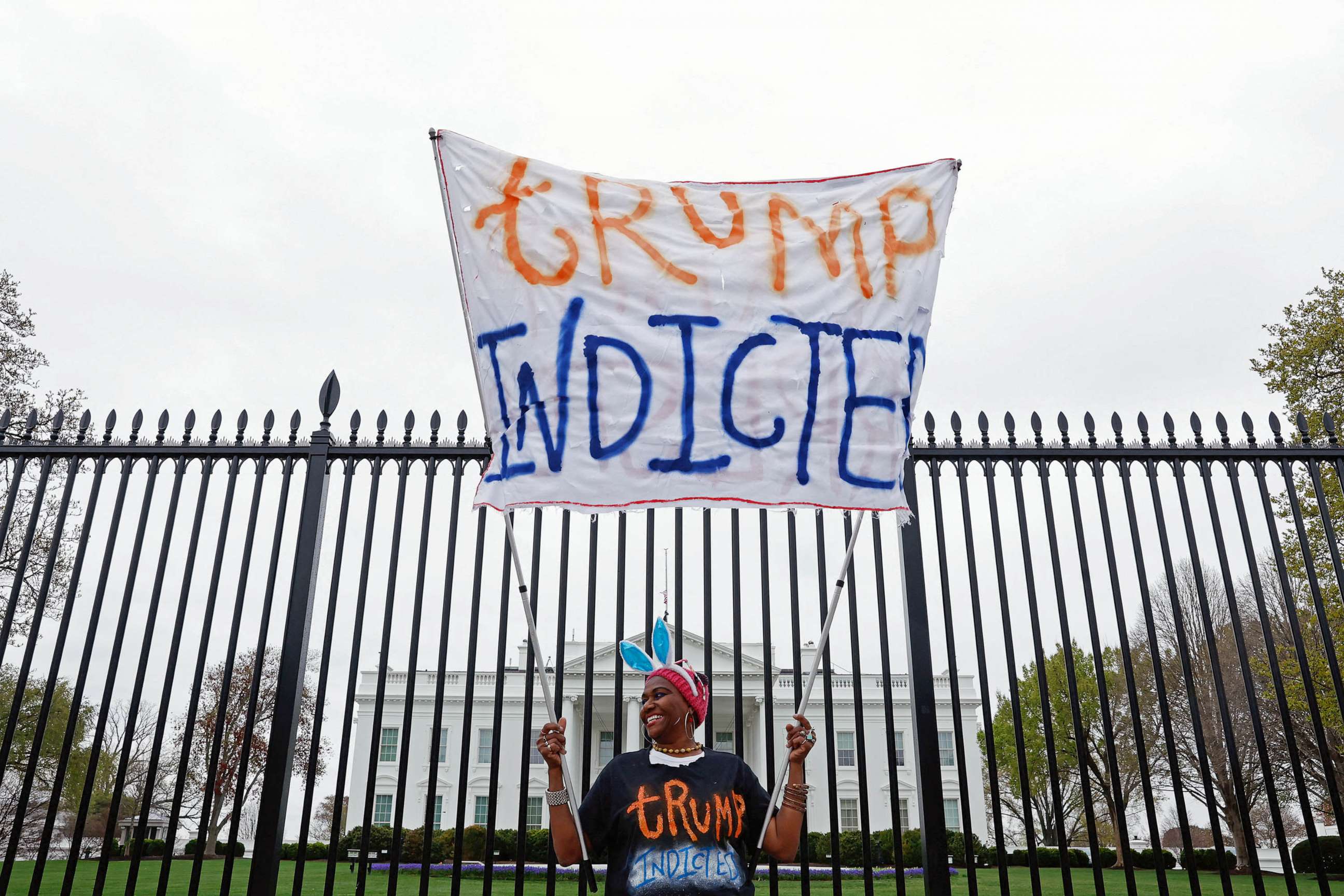 PHOTO: Nadine Seiler holds a "Trump Indicted" sign in front of the White House after former U.S. President Donald Trump's indictment by a Manhattan grand jury following a probe into hush money paid to porn star Stormy Daniels,in Washington, March 31, 2023